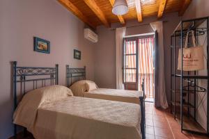 Lova arba lovos apgyvendinimo įstaigoje Maqueda Apartment by Wonderful Italy