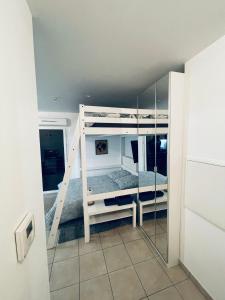 a room with two bunk beds with a mirror at Appartement Lahcen in Thorigny-sur-Marne