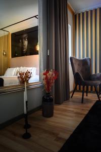 een kamer met een spiegel, een stoel en een bed bij Boutique Wine Hotel Panorama in Macedo de Cavaleiros