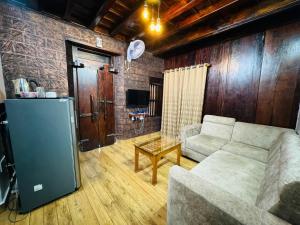 a living room with a couch and a refrigerator at THE HERiTAGE in Cochin
