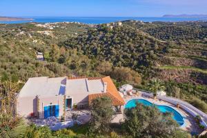 an aerial view of a house with a swimming pool at Pano Stalos Villas in Stalos