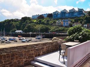 a balcony with a table and chairs overlooking a marina at 4 Bed in Ilfracombe 45121 in Ilfracombe