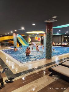 a group of people in a swimming pool at Castello apartman Kopaonik in Kopaonik