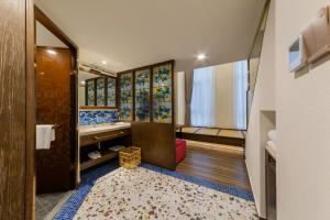 a bathroom with a walk in shower and a sink at Overseas Chinese Town Nanyang Inn in Shenzhen