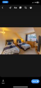 a bedroom with two beds in a room at Neptunes Rest Guest Hotel in Stranraer