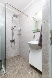 a bathroom with a sink and a shower at Radiant Retreat: Bright 1BD Haven in Plovdiv in Plovdiv