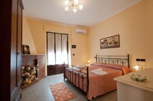 a bedroom with a bed and a fireplace at Agriturismo Il Crinale in Castorano