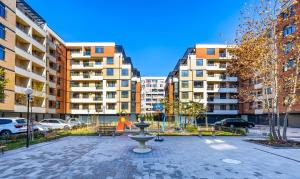 a park with a fountain in the middle of a city at Radiant Retreat: Bright 1BD Haven in Plovdiv in Plovdiv