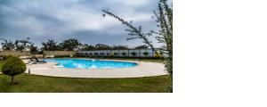 a swimming pool in the yard of a building at Private Room in villa in Bāgalūr