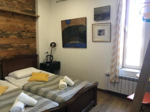 a bedroom with two twin beds and a window at Gallery Guesthouse in Yerevan
