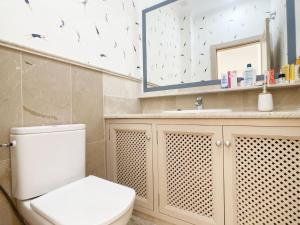 a bathroom with a toilet and a sink and a mirror at Spanish Connection - La Manga Golf Club in Atamaría