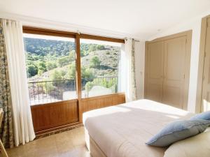 a bedroom with a bed and a large window at Spanish Connection - La Manga Golf Club in Atamaría