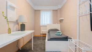 a small room with a bed and a desk at Zimmer 1230 in Vienna