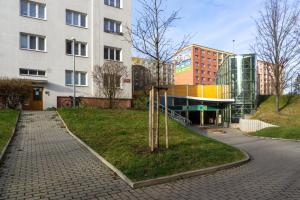 a group of buildings in a city with a street at Jana's WoW apt, 2BR, Metro next door, near the airport in Prague