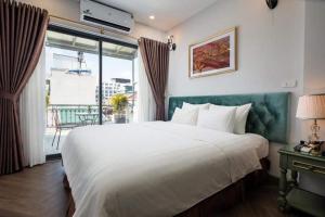 Ліжко або ліжка в номері Gatsby Central Hotel Hanoi
