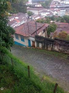an old building with blue doors in a city at Casa Jabuticabeira in Ouro Preto