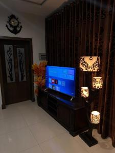 a living room with a flat screen tv on a entertainment center at Sunrise Residence in Islamabad