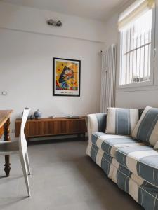 a living room with a couch and a table at MonteRoom-Apartments in Bologna