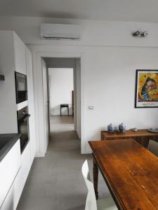 a living room with a wooden table and a dining room at MonteRoom-Apartments in Bologna