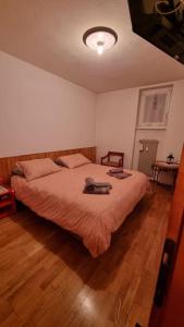 a bedroom with a large bed with a wooden floor at Trento, Monte Bondone, casa tipica di montagna in Norge