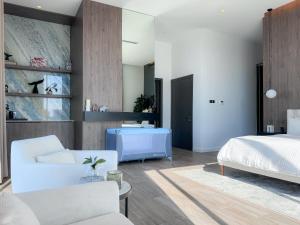 a bedroom with a bed and a living room at Villa 72 RAK in Ras al Khaimah