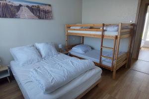 a bedroom with two bunk beds and a bed at Maison neuve 6/8p à La Cotinière in La Cotinière