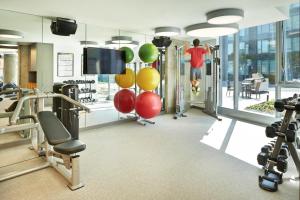 a gym with cardio equipment and a flat screen tv at Pioneer Square studio w lounge gym nr bay SEA-587 in Seattle