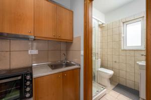 a small kitchen with a sink and a toilet at Elli Beach Downtown Apartments in Rhodes Town