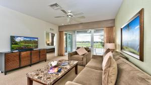 a living room with a couch and a tv at Genoa Vacation Rental in Naples