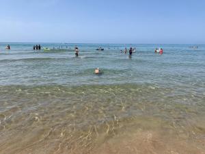 a group of people in the water at the beach at Sperlonga Apartment in Sperlonga