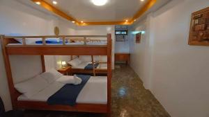 a room with two bunk beds in a room at RGL Place Siargao in General Luna