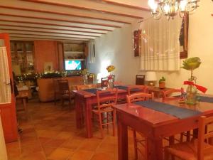 a dining room with wooden tables and chairs at H Rural Molino del Rio Argos in Benablón