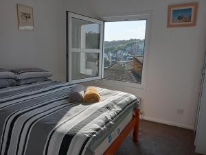 a bedroom with a bed and a large window at Tackleway privileged Sea Views Hastings old town whole house 3 beds in Hastings