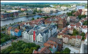 an aerial view of a city with a river and buildings at Arkona Residence Szczecin in Szczecin