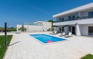 - une piscine en face d'une maison dans l'établissement Modern villa Casa Storija with pool in Novigrad, à Bužinija