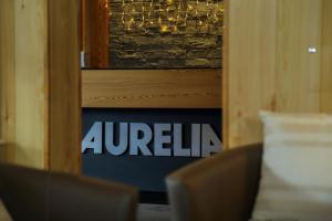 a sign in a door with the wordinia on it at Hôtel Aurélia in Saint-Lary-Soulan