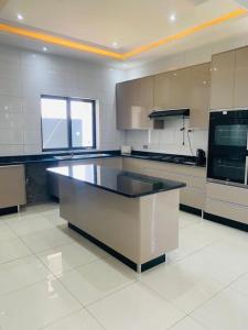 a large kitchen with a large island in the middle at Executive 4 bedroom house with 4 beds . in Lusaka