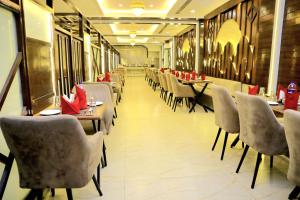 a dining room with tables and chairs in a restaurant at Pineberry Hotels in Amritsar