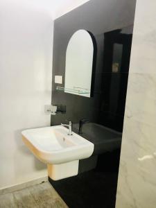 a bathroom with a sink and a bath tub at Aura in Unawatuna
