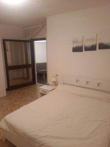 a bedroom with a white bed and a balcony at Terrace Home in Saint Vincent