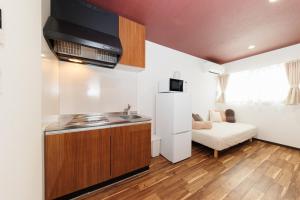 a kitchen with a sink and a couch in a room at 西九条 CHILL - Nishikujo CHILL in Osaka +25 photos
