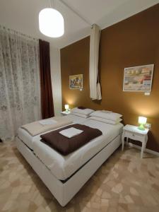 a bedroom with a large bed and two tables at Zeljko's luxury hostel in Vicenza
