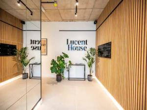 a lobby of a light house with potted plants at Pass the Keys Blend of Luxury and Elegance in the Heart of London in London