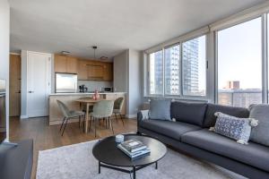 a living room with a couch and a table at Midtown West 2br w gym roofdeck nr Hudson NYC-1395 in New York