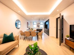 a living room with a couch and a table at Pass the Keys Modern Exuberance and Luxury at Lucent House in London