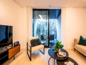 a living room with a couch and a tv at Pass the Keys Modern Exuberance and Luxury at Lucent House in London