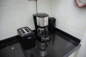 a blender sitting on a counter next to a trash can at GWETH STUDIO APARTMENT in Nairobi