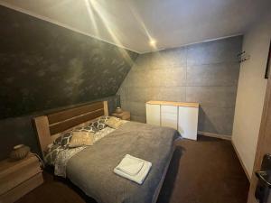 - une petite chambre avec un lit et un mur noir dans l'établissement Zajazd Gronków, à Gronków