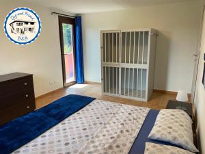 a bedroom with a large bed and a window at BnB Dog and Friend in Rocchetta Tanaro