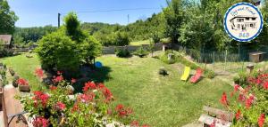 a garden with flowers and a sign in the background at BnB Dog and Friend in Rocchetta Tanaro